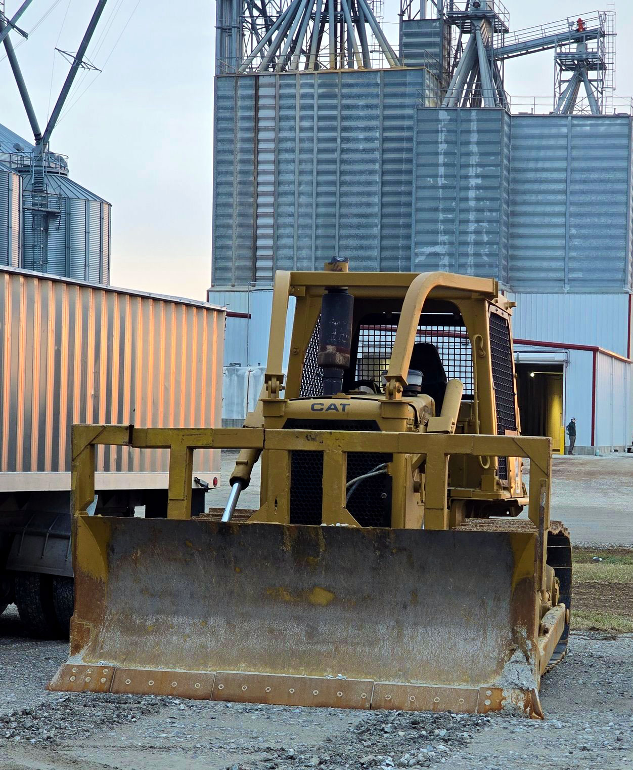 CAT dozer serviced at the shop next to grain bins