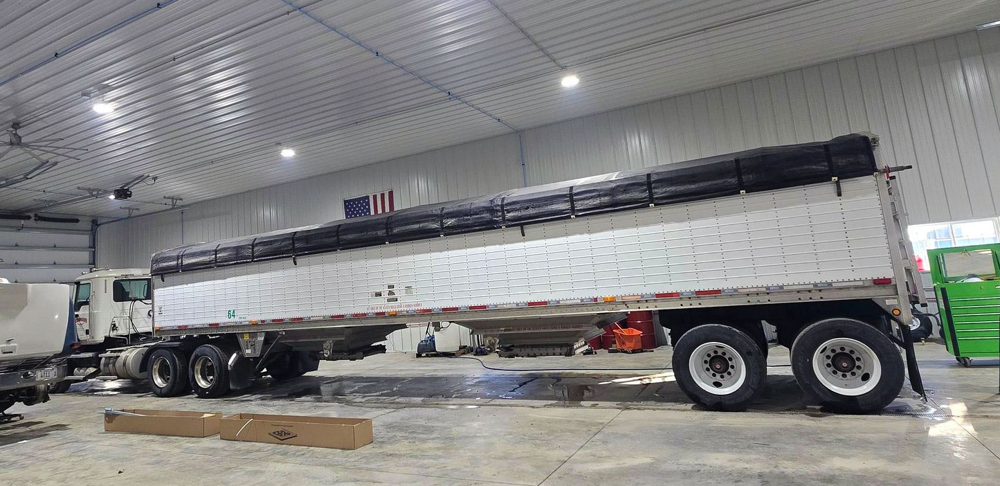 Grain hopper trailer in for service inside the shop
